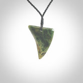 This is a lovely New Zealand Jade, pounamu drop pendant. Hand carved for us by Ric Moor. It is bound with an adjustable black coloured cord which is length adjustable. Free worldwide shipping.